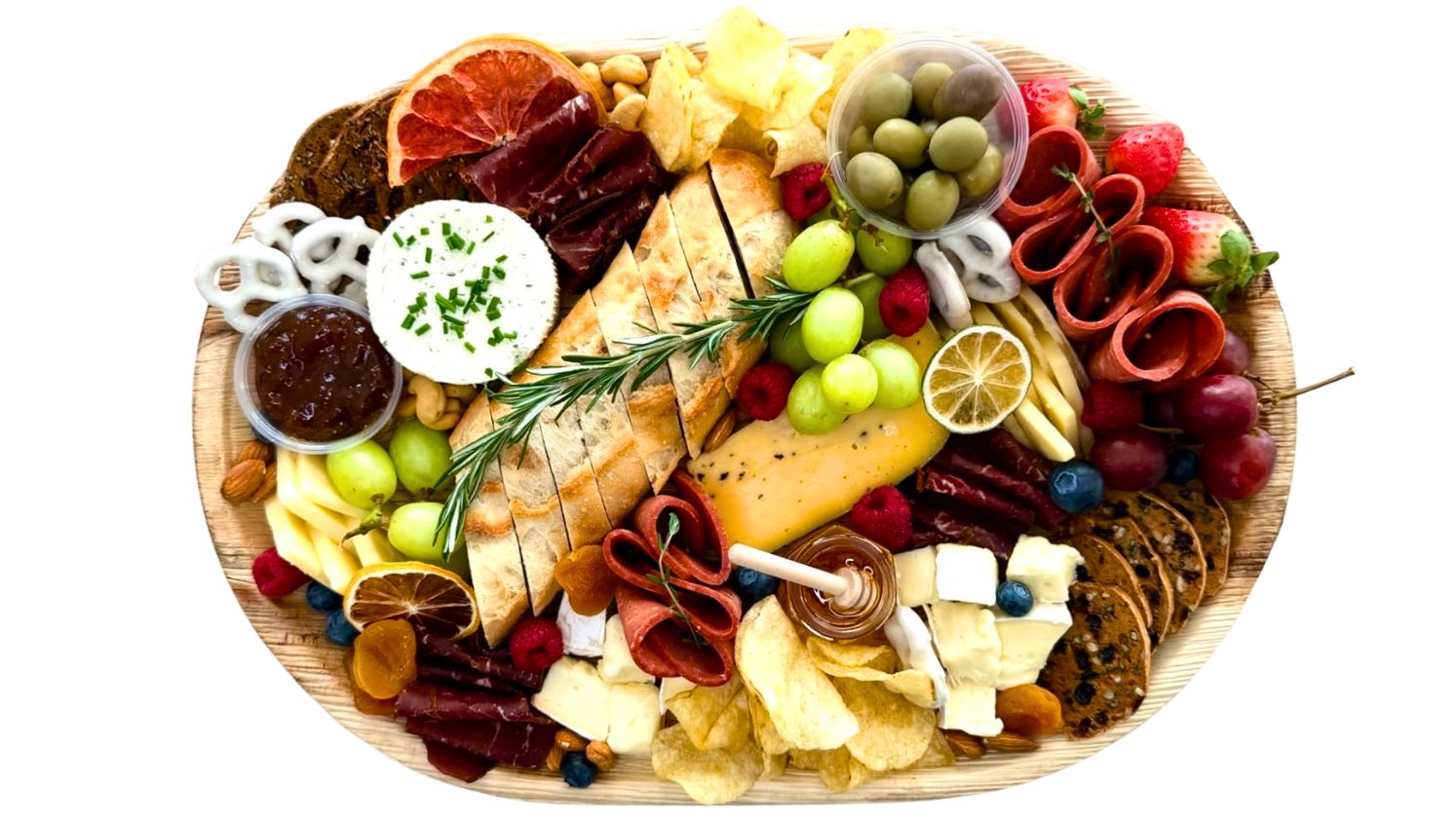 Assorted charcuterie board with meats, cheeses, fruits, and crackers on a wooden board.